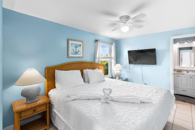 bedroom with ceiling fan, connected bathroom, sink, and light tile patterned floors