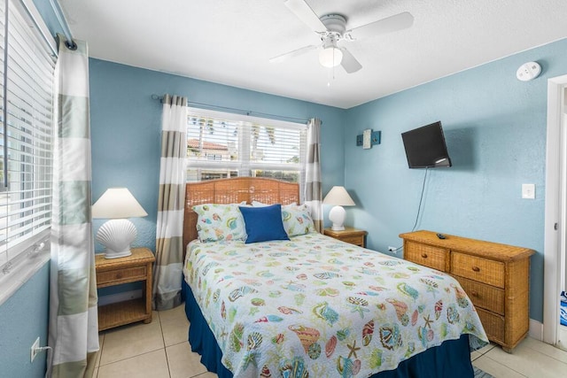 tiled bedroom with ceiling fan