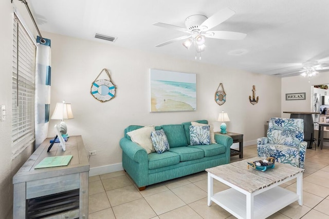 living room with ceiling fan and light tile patterned floors