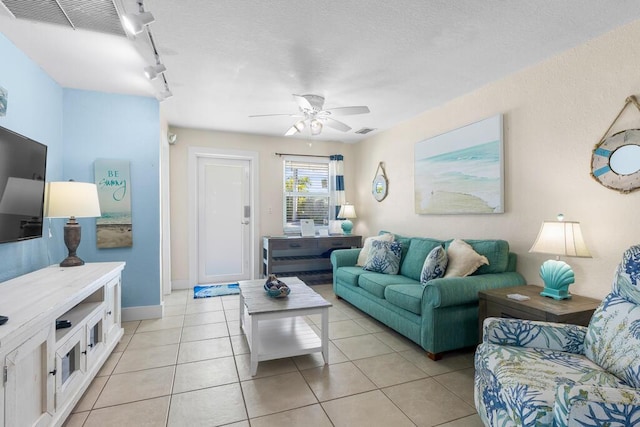 tiled living room featuring ceiling fan and track lighting