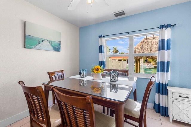 tiled dining room featuring ceiling fan