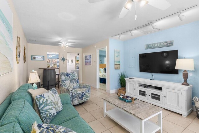 living room featuring light tile patterned floors and ceiling fan