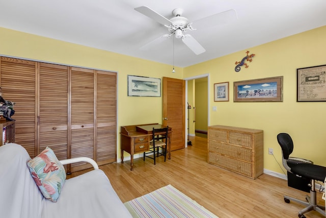 home office with light wood-style floors, baseboards, and a ceiling fan