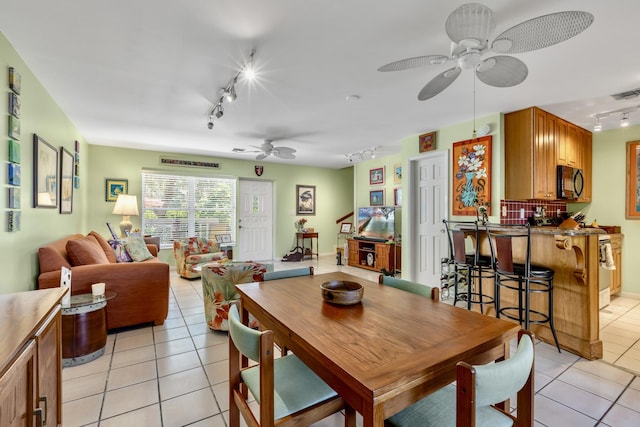 dining room featuring light tile patterned floors, visible vents, a ceiling fan, and rail lighting