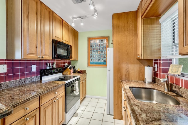 kitchen featuring electric stove, backsplash, black microwave, a sink, and light tile patterned flooring