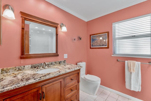 bathroom featuring crown molding, toilet, vanity, tile patterned flooring, and baseboards