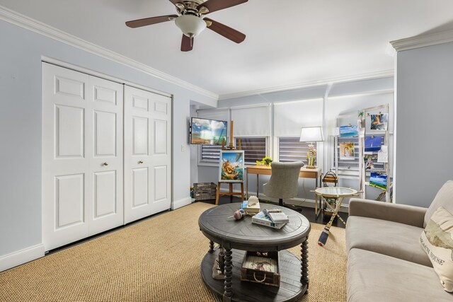 carpeted living room with ornamental molding and ceiling fan