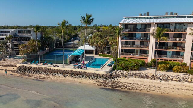 view of pool featuring a view of the beach and a water view