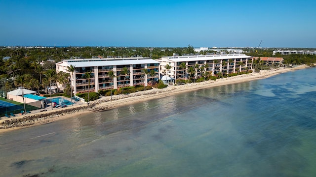 drone / aerial view featuring a beach view and a water view