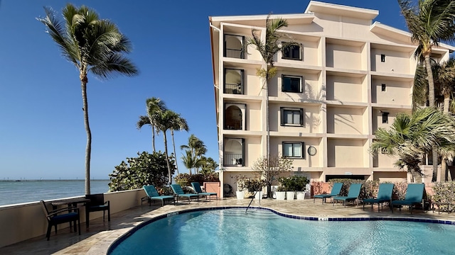 view of pool with a water view