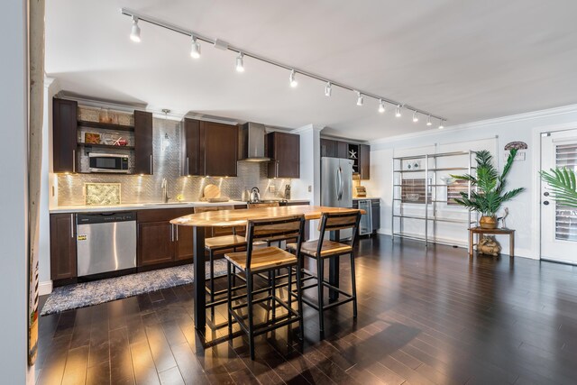 kitchen with stainless steel appliances, tasteful backsplash, dark hardwood / wood-style flooring, and wall chimney exhaust hood