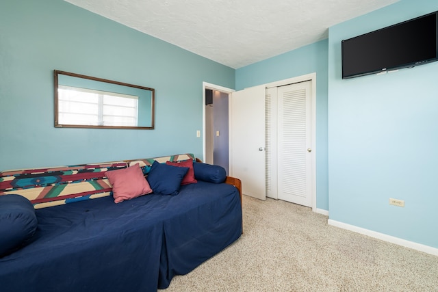 bedroom with a textured ceiling and a closet