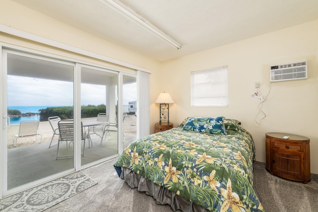 carpeted bedroom with multiple windows, a water view, access to exterior, and a wall unit AC