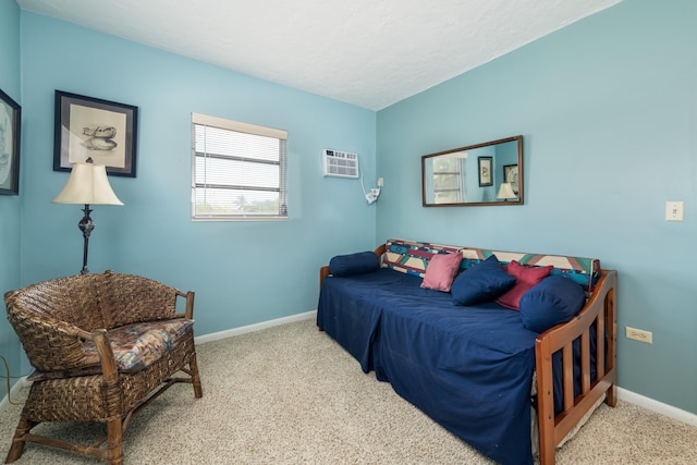 bedroom with light carpet, an AC wall unit, and a textured ceiling