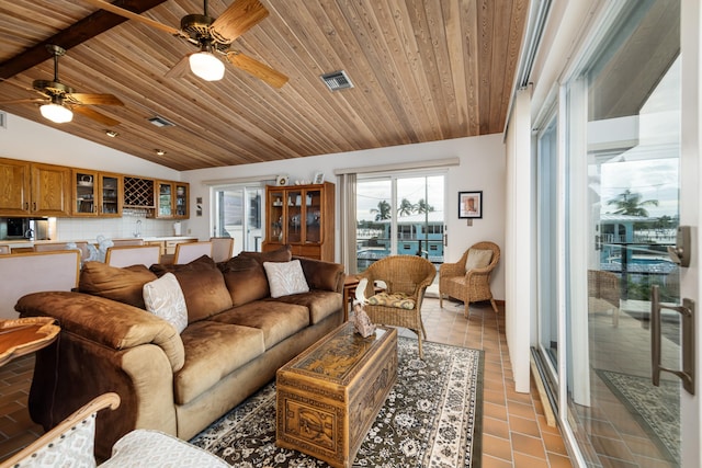 living room featuring lofted ceiling, wooden ceiling, ceiling fan, and light tile patterned flooring