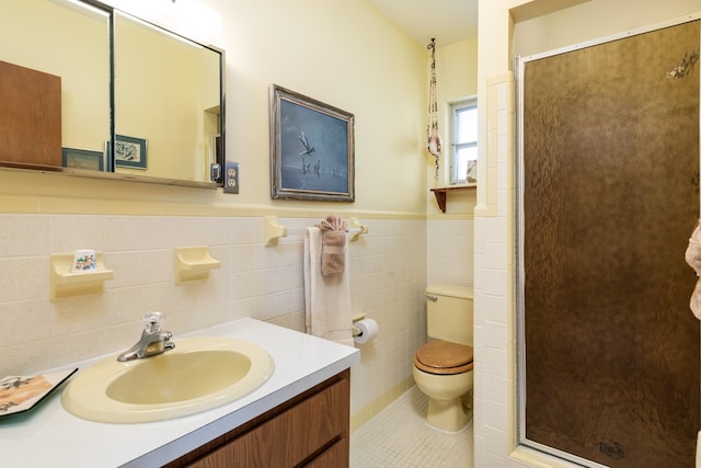 bathroom featuring walk in shower, tile patterned floors, toilet, tile walls, and vanity