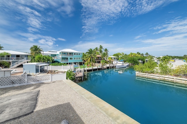 view of pool with a dock and a water view