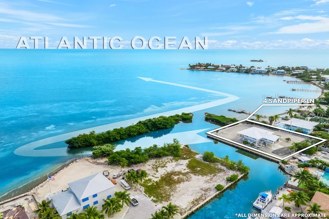 drone / aerial view with a water view and a beach view