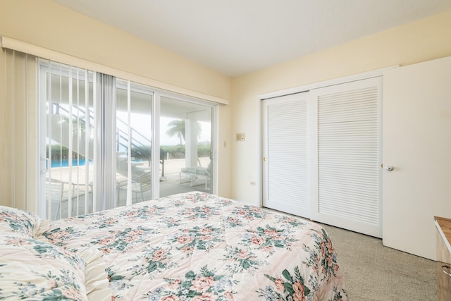 bedroom featuring carpet, a closet, and access to outside