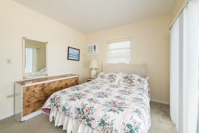 bedroom with a wall unit AC and light carpet