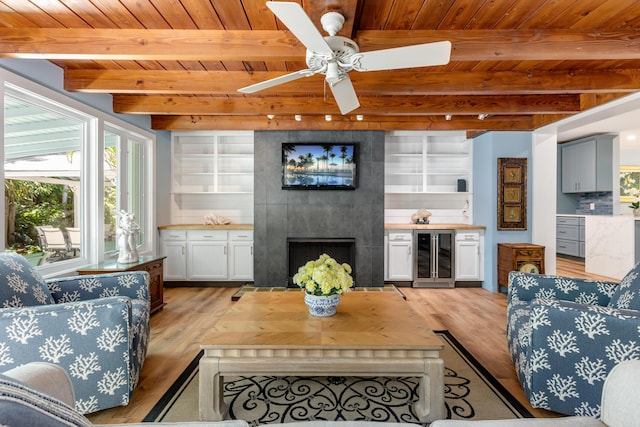 1706 Seminary St, Key West, FL 33040 - living area with beverage cooler, a wood ceiling with exposed beams, light wood-style flooring, a large fireplace, and ceiling fan