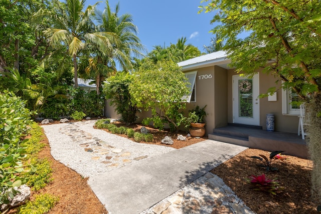 1706 Seminary St, Key West, FL 33040 - property entrance with stucco siding and a metal roof