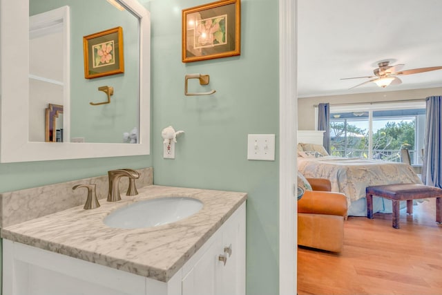 bathroom with ceiling fan, vanity, and wood-type flooring