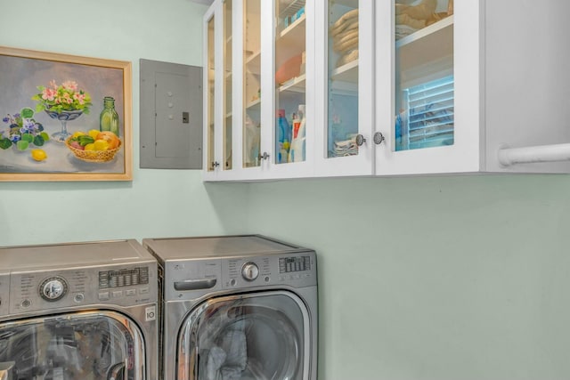 washroom featuring cabinets, independent washer and dryer, and electric panel