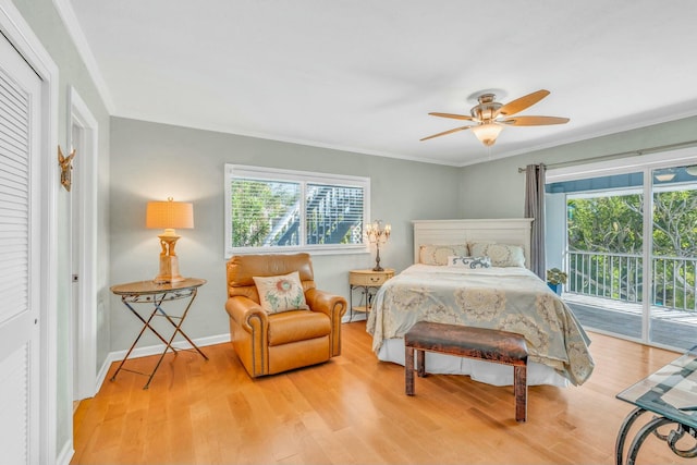 bedroom featuring multiple windows, crown molding, and access to outside