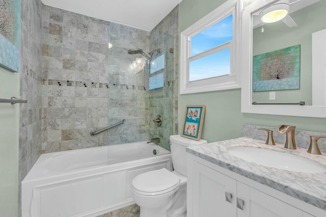 full bathroom with vanity, toilet, and tiled shower / bath