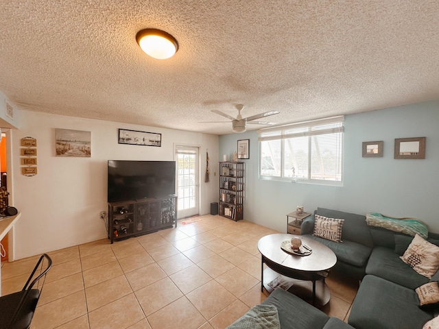 tiled living room featuring a textured ceiling and ceiling fan