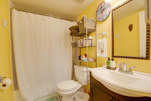 full bathroom featuring shower / tub combo with curtain, toilet, and vanity