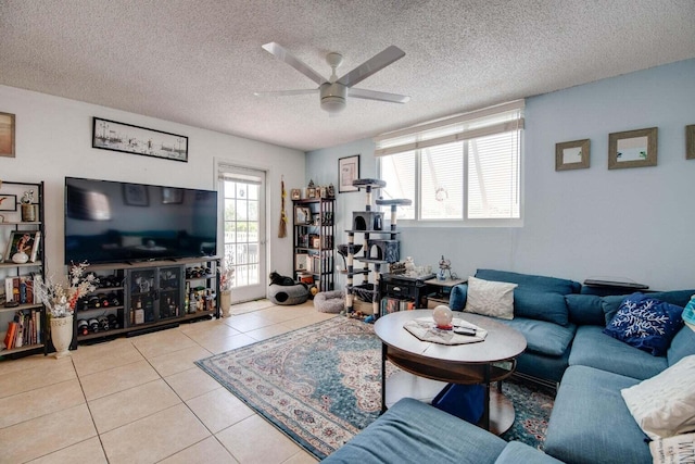 tiled living room featuring a textured ceiling and ceiling fan