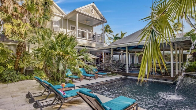 view of patio / terrace with ceiling fan, a swimming pool, a balcony, and a gazebo