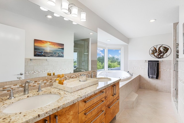 bathroom with tile patterned floors, separate shower and tub, vanity, and backsplash