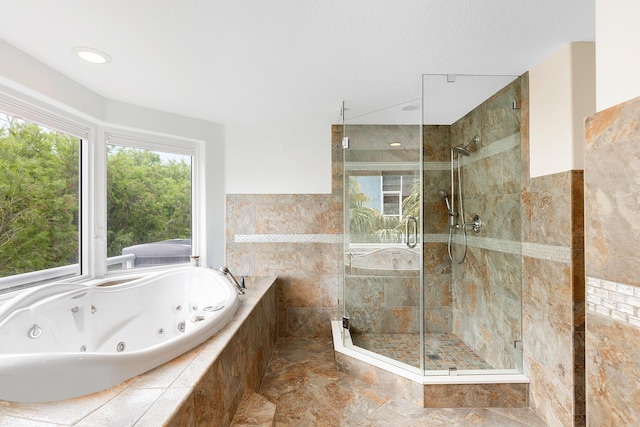 bathroom featuring shower with separate bathtub