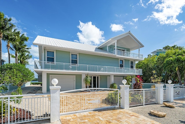 view of front of home featuring a garage and a balcony