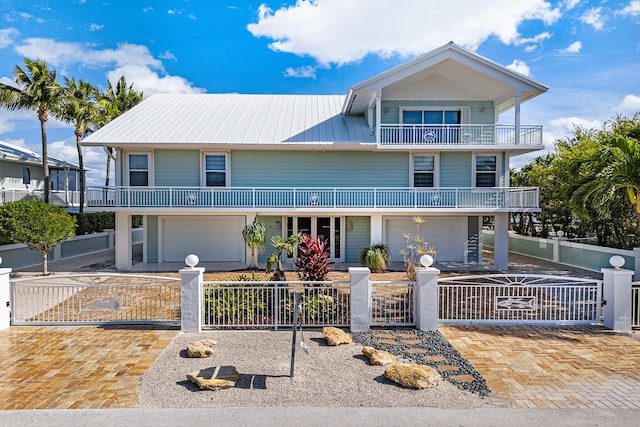 view of front of home with a garage and a balcony