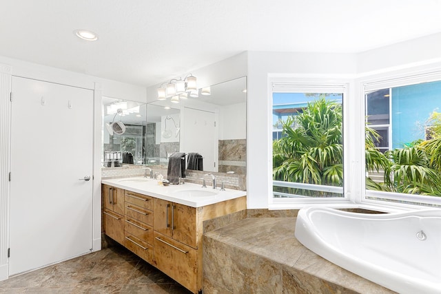 bathroom with vanity and shower with separate bathtub