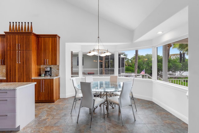 dining area featuring plenty of natural light and high vaulted ceiling