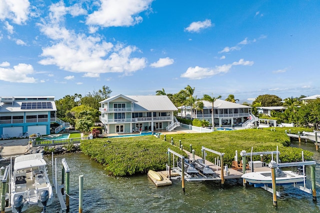 dock area featuring a balcony and a water view