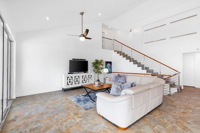 living room featuring ceiling fan and high vaulted ceiling