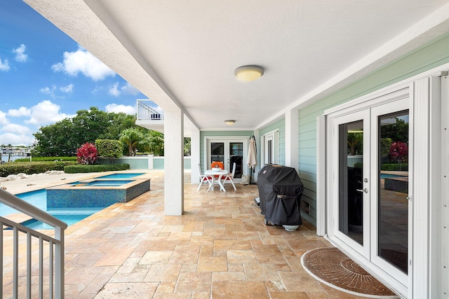 view of pool featuring an in ground hot tub, area for grilling, a patio, and french doors