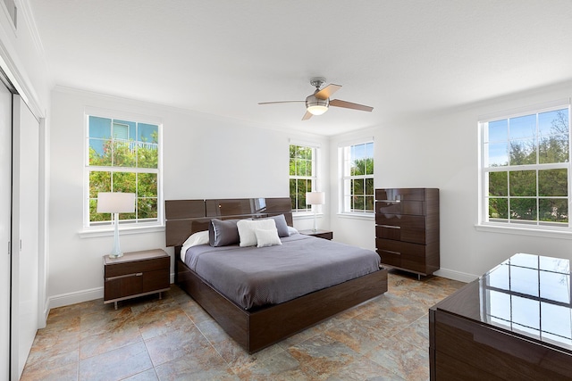 bedroom featuring crown molding, a closet, and ceiling fan