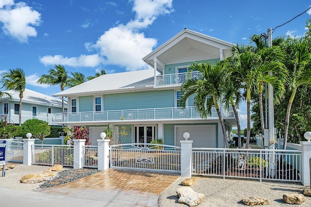 view of front of house featuring a garage and a balcony