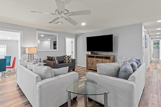 living room with hardwood / wood-style flooring and ceiling fan