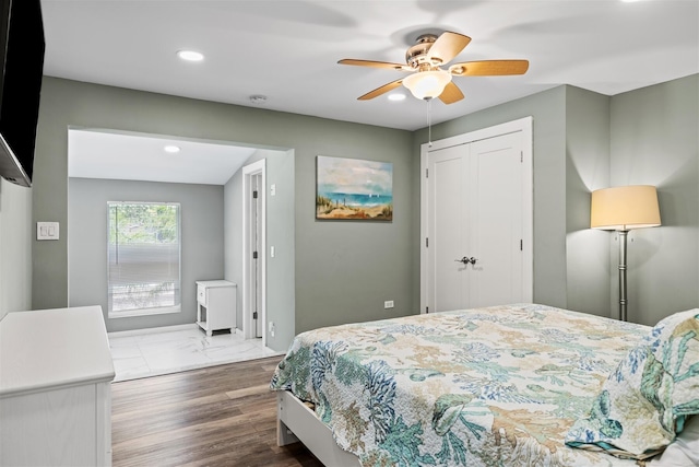 bedroom featuring wood-type flooring, a closet, and ceiling fan