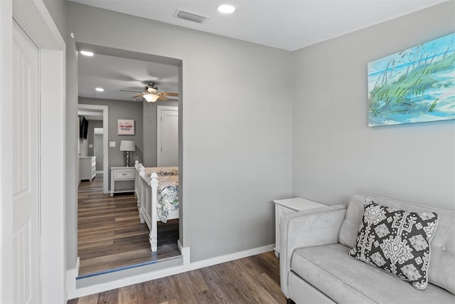 sitting room featuring dark hardwood / wood-style floors and ceiling fan