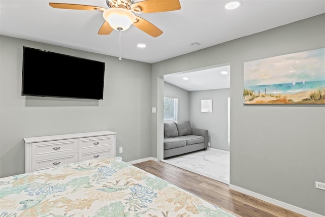 bedroom with ceiling fan and light wood-type flooring