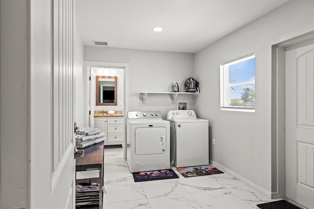 clothes washing area with separate washer and dryer